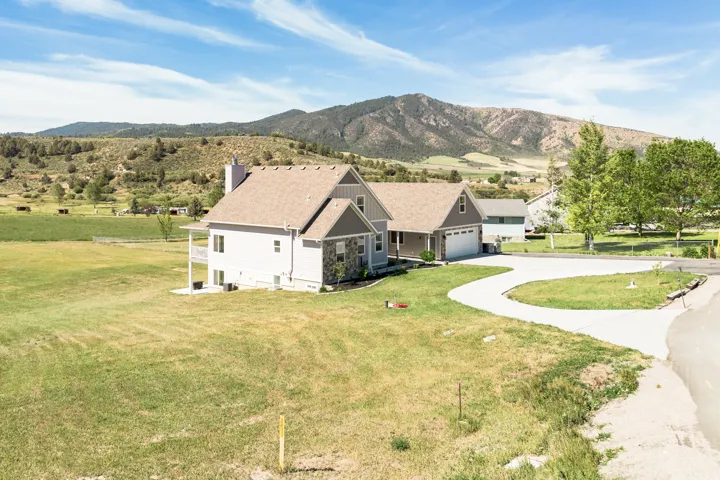 Two-story residence with a multi-level roofline, attached two-car garage, and a concrete driveway
