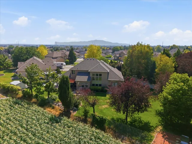 Expansive rear exterior featuring a multi-level design, multiple windows, and a large lawn area