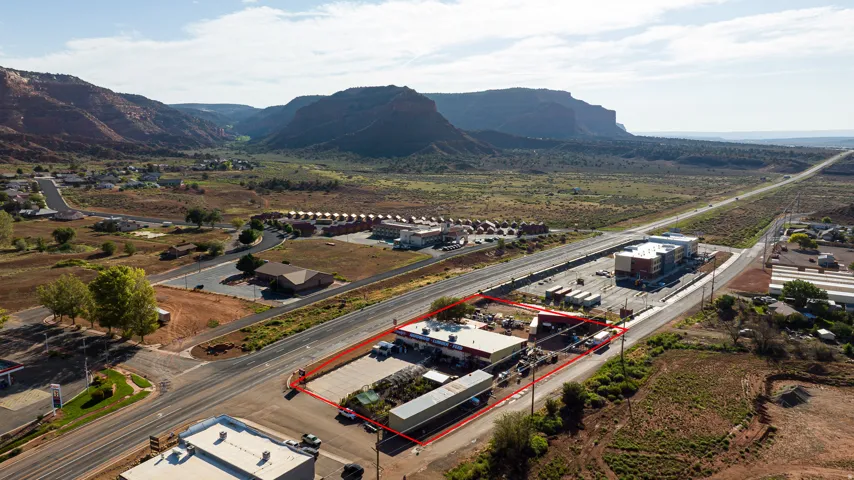 Commercial building with a paved parking area and direct road frontage