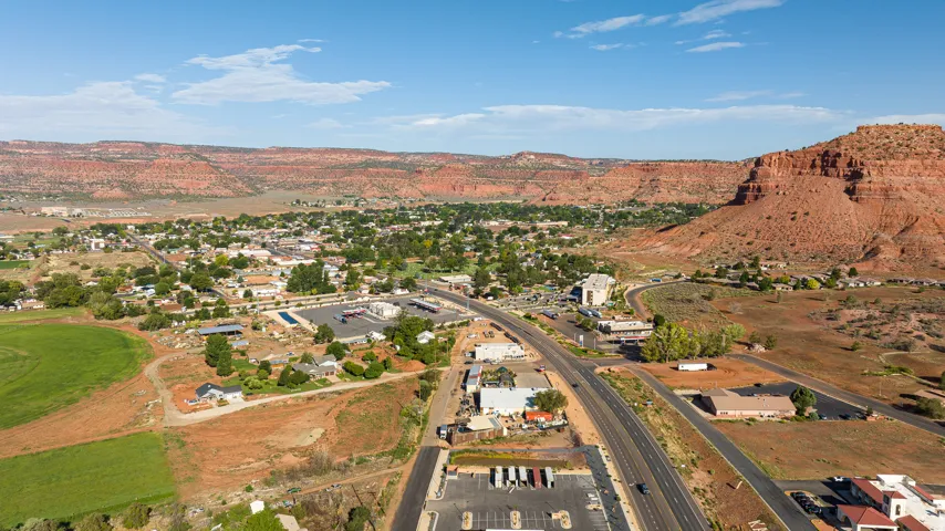 Expansive aerial view showcasing a developed area with extensive roadways, commercial structures, and residential buildings
