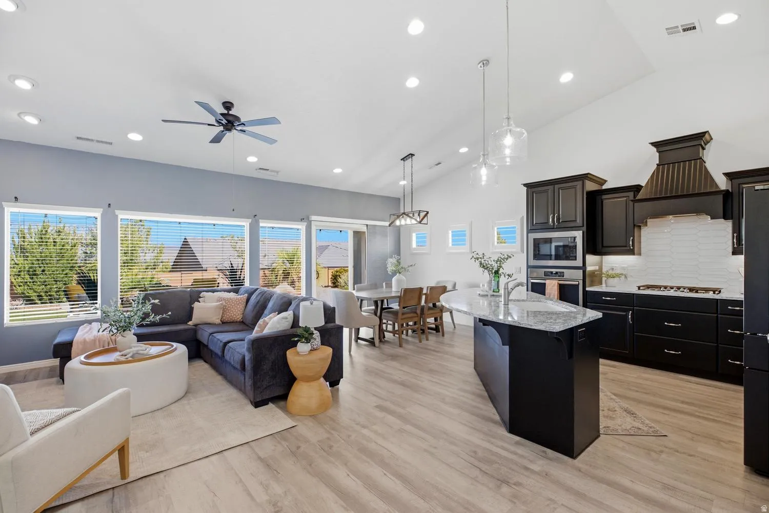 Vaulted ceilings, recessed lighting, and wood-finish flooring