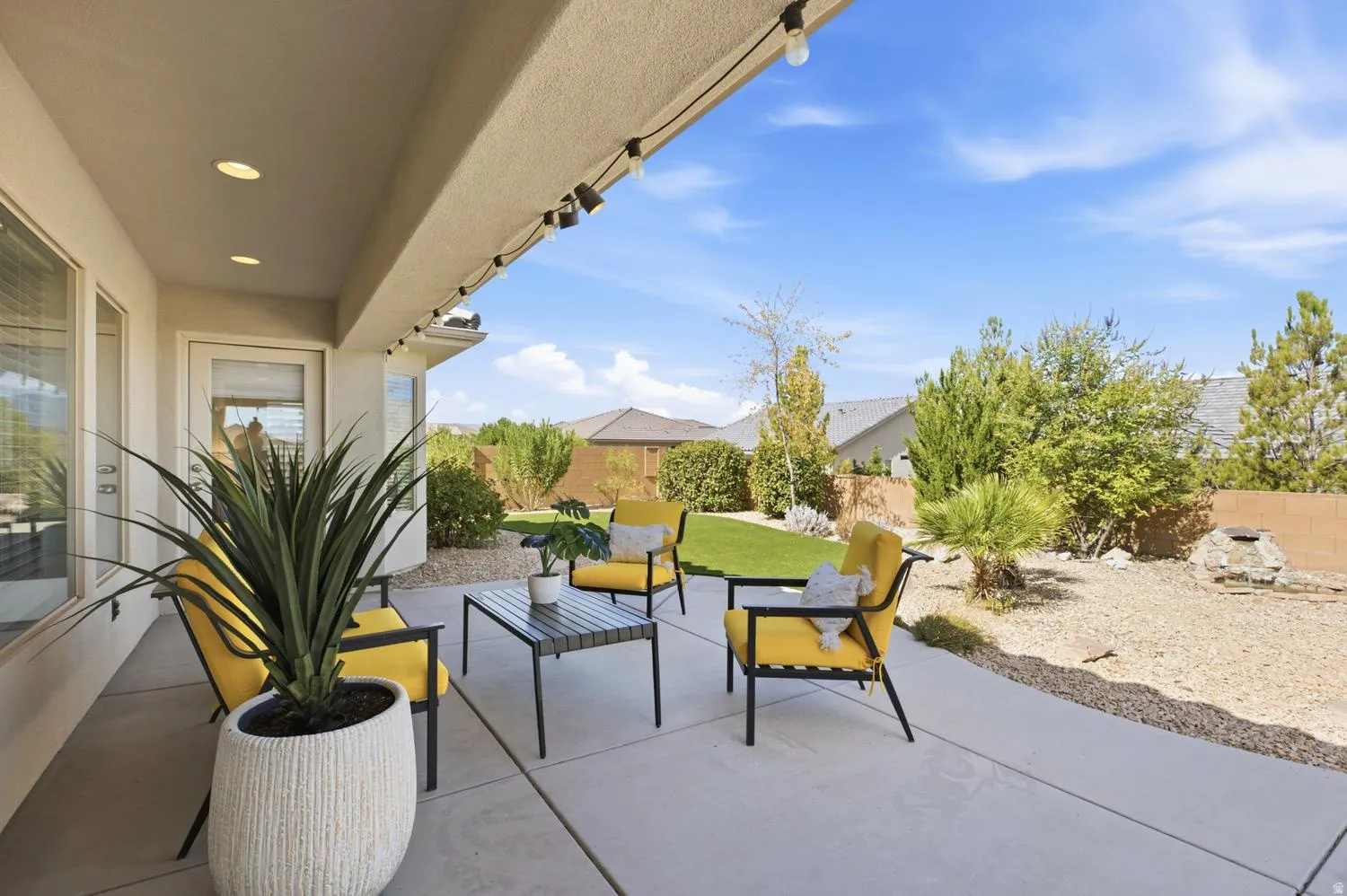 Concrete patio with string lighting and recessed overhead lighting