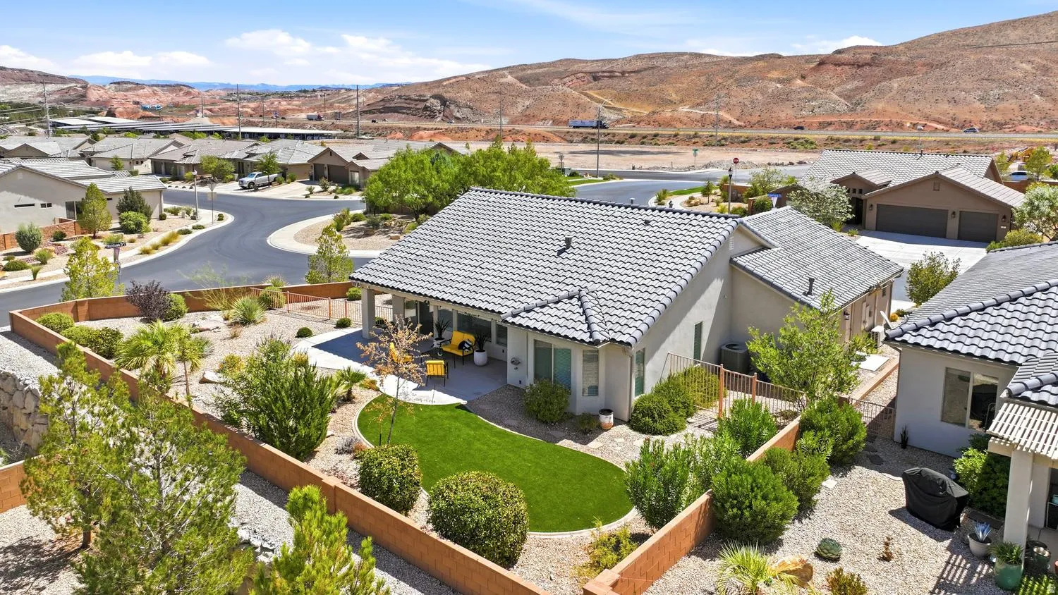 Private backyard with patio, artificial turf, and desert landscaping