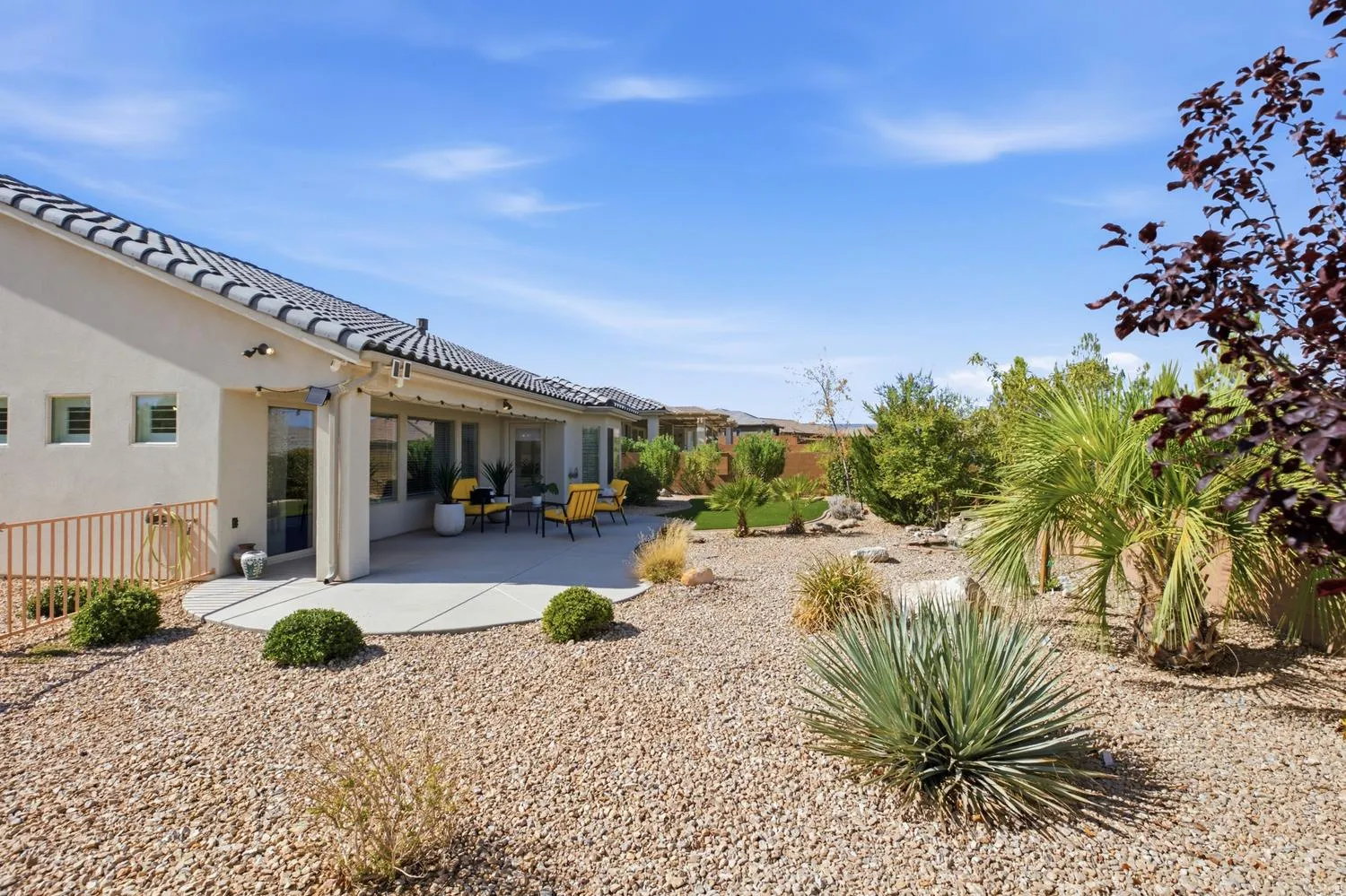 Exterior featuring a tiled roof, stucco siding, and a covered patio
