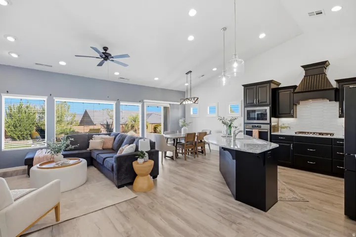 Vaulted ceilings, recessed lighting, and wood-finish flooring
