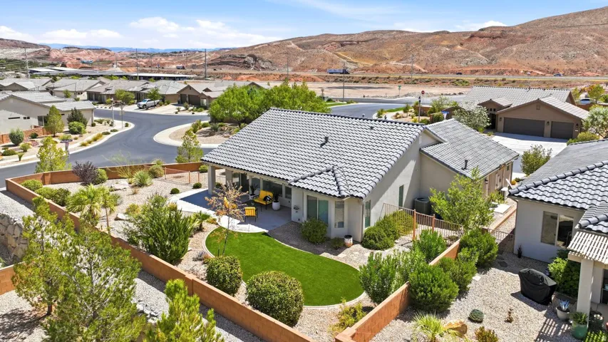 Private backyard with patio, artificial turf, and desert landscaping