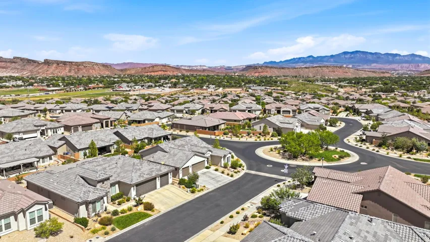 Residential neighborhood with mountain backdrop featuring a manicured roundabout