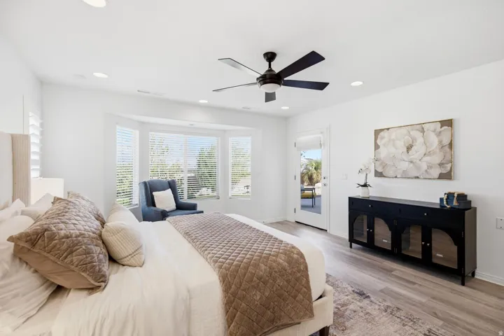 Recessed lighting, wood-finish flooring, and a ceiling fan with integrated lighting