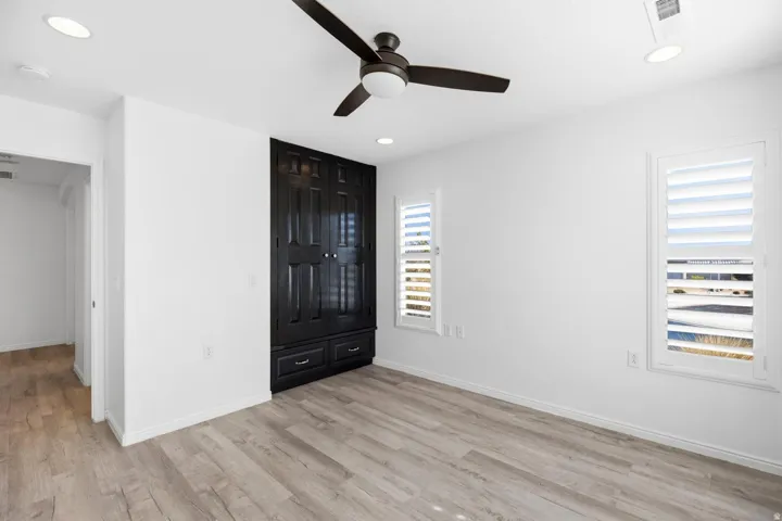 Light wood-finish flooring with white walls