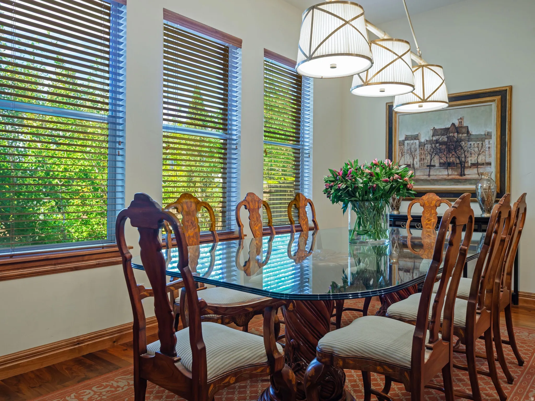 Multiple windows with wood-finish blinds, wood-finish trim, and wood-finish flooring