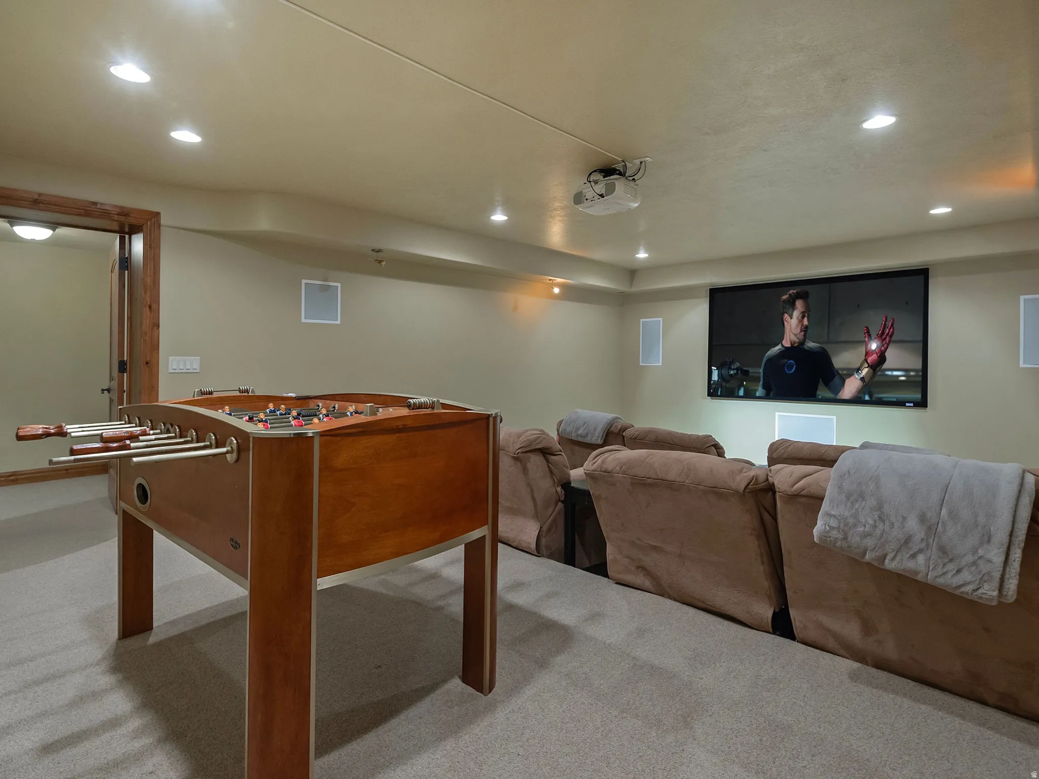 Home Theater, Recessed lighting, wood-finish door frame, built-in wall speakers, mounted projector, and a large projection screen