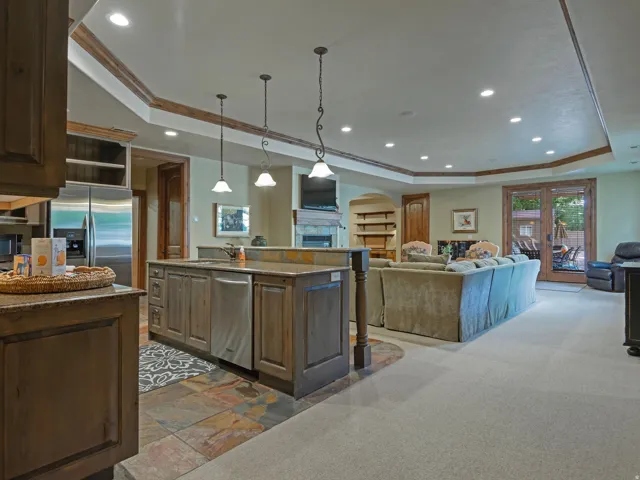 Walk-out Basement, Open-concept living area with tray ceiling, recessed lighting, and wood-finish trim