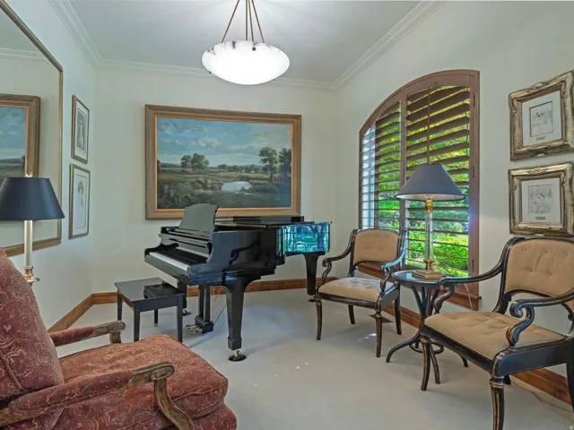 Arched window with plantation shutters, crown molding, and a semi-flush mount ceiling fixture