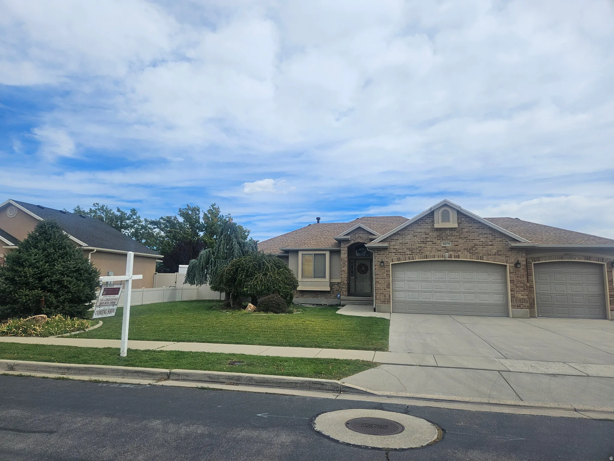 Brick/Stucco Exterior with Arched Entry Attached 3-car Oversized Garage, RV Parking, and Mature Landscaping