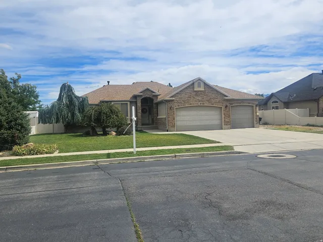 Brick/Stucco Exterior with Arched Entry Attached 3-car Oversized Garage, RV Parking, and Mature Landscaping