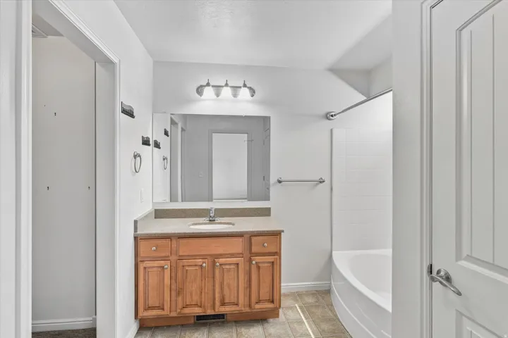 Wood-finish vanity with an integrated sink and light-toned countertop