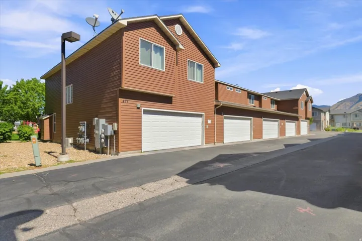 Brown siding exterior with multiple garage doors
