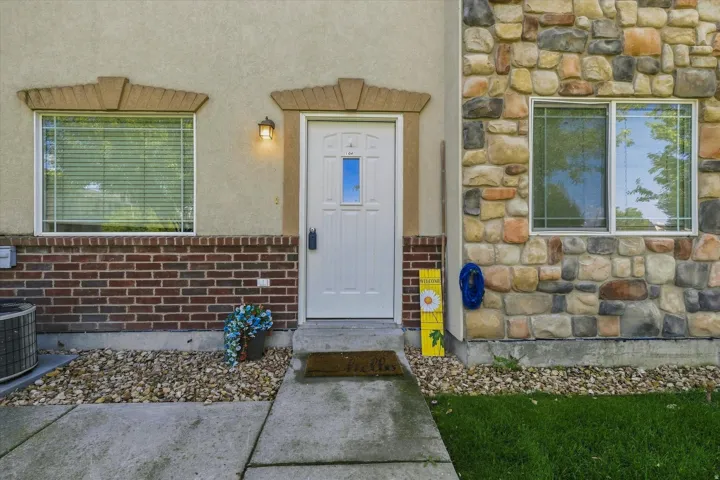 Exterior featuring a combination of stucco, brick, and stone facade