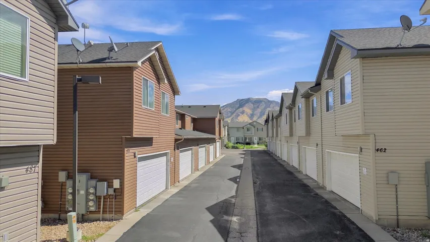 Brown and beige siding exteriors with white garage doors