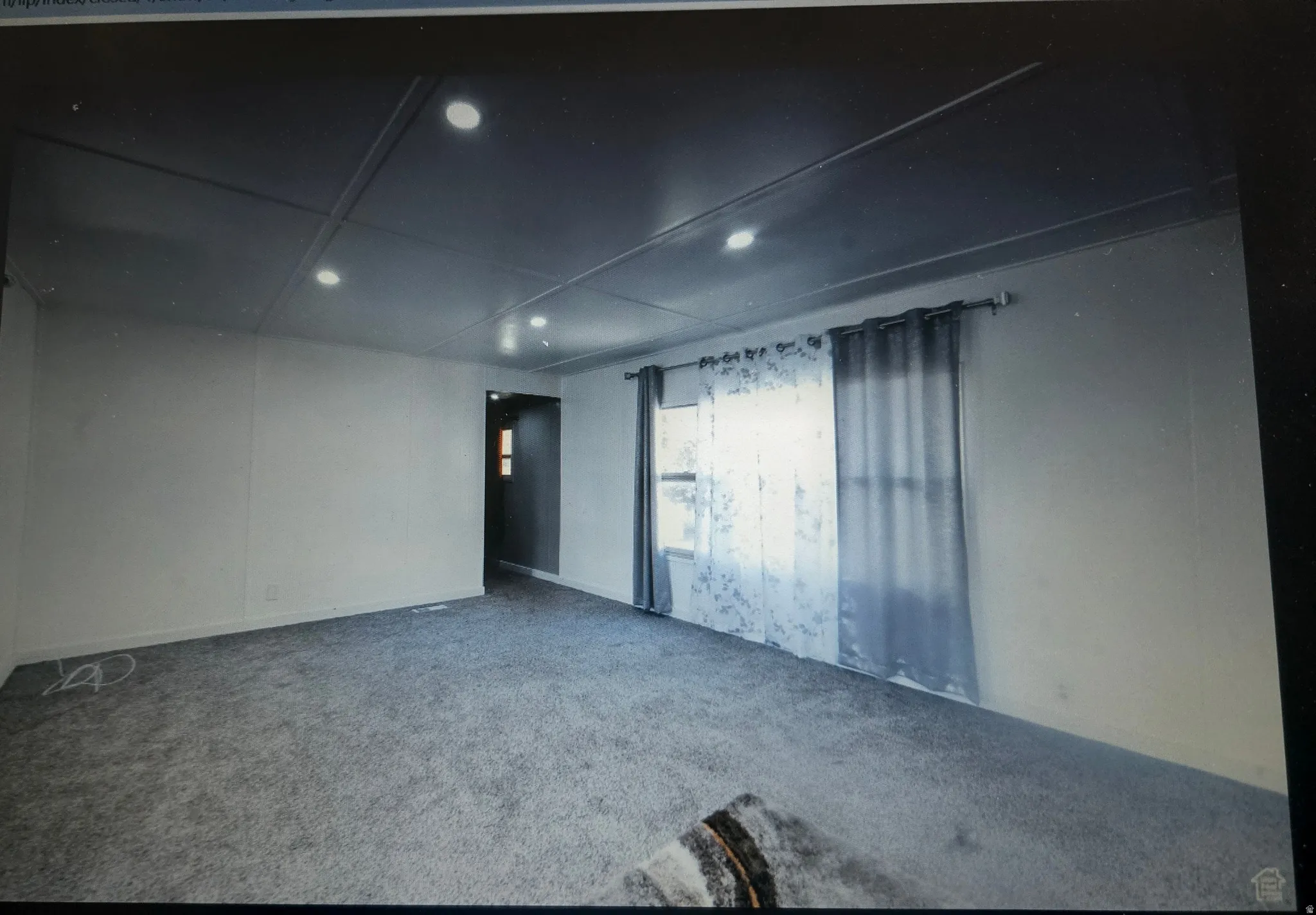 Living room with recessed ceiling lighting, gray carpeting, neutral wall finishes, and a window with curtain rod