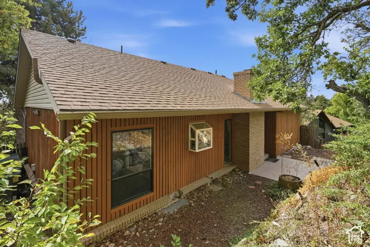 Brown shingle roof with a brick chimney