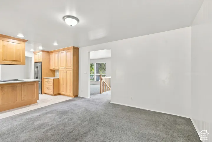 Kitchen featuring wood cabinetry, stainless steel appliances, and white countertops
