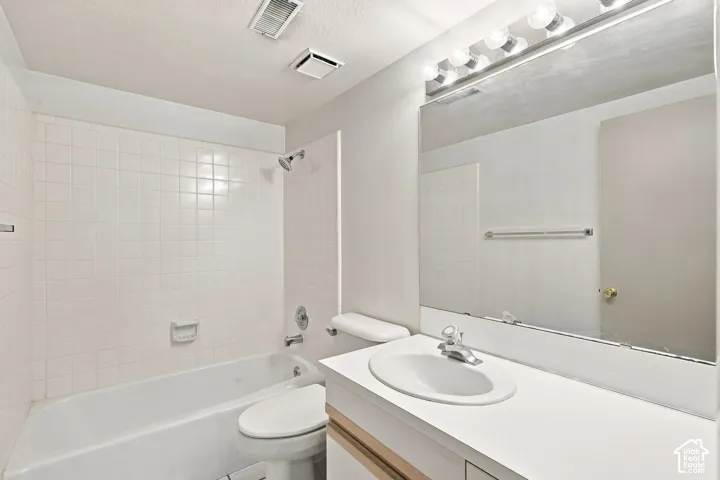 White tiled shower and tub combination