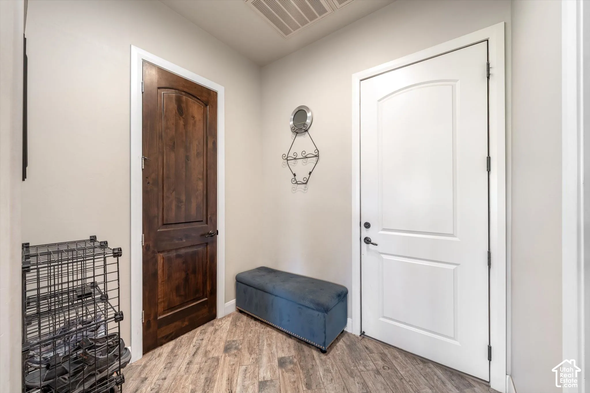 Wood-finish flooring, white panel door, and dark wood-finish door