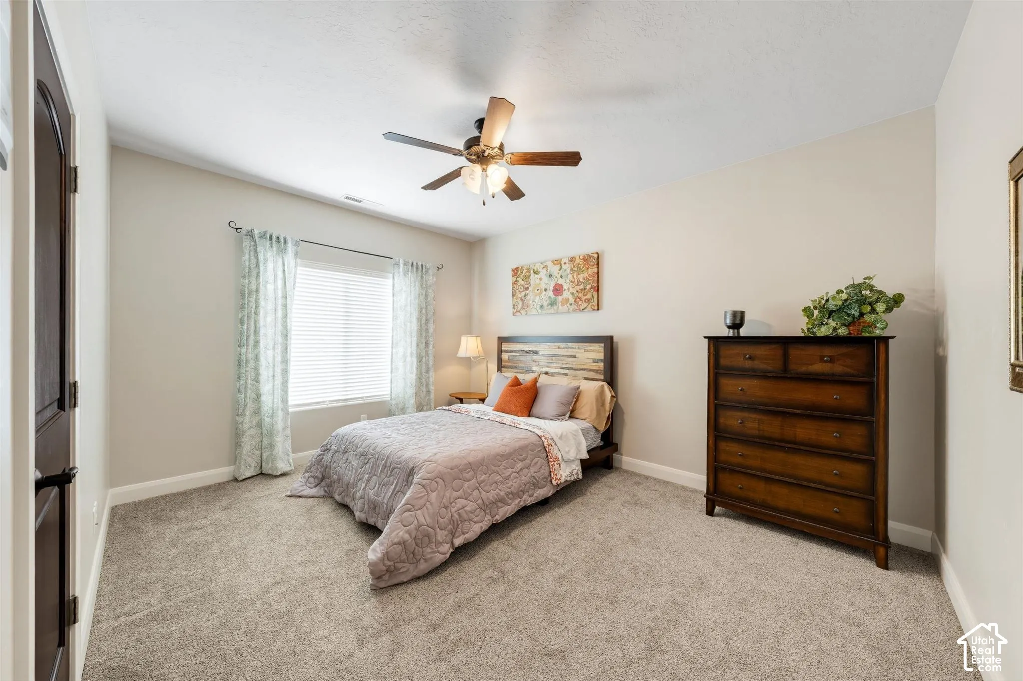 Recessed window with blinds, overhead ceiling fan, and light-colored wall paint
