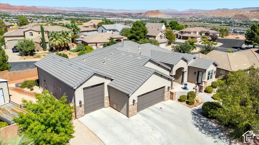 Stucco exterior with stone accents, tile roofing, and a prominent arched entryway