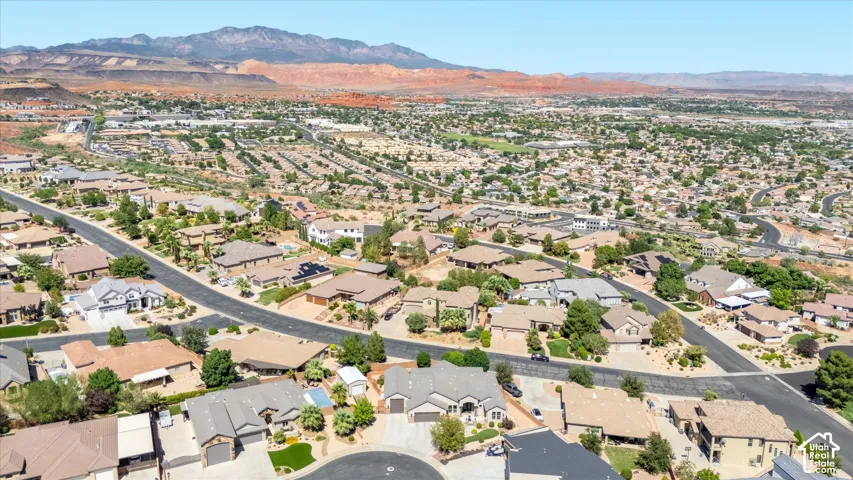 Expansive neighborhood setting with numerous residential properties, paved streets, and abundant mature landscaping