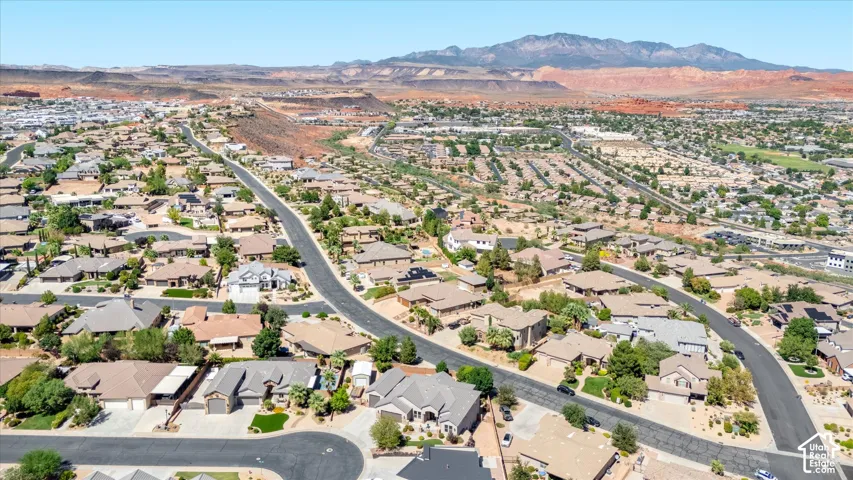 Extensive residential area with desert mountain backdrops, paved roadways, and mature landscaping
