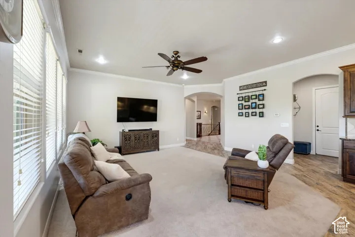 Vaulted ceilings with crown molding, recessed lighting, and a ceiling fan