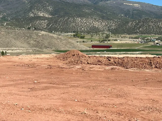 Expansive land parcel with surrounding mountain terrain