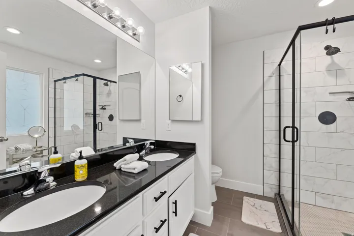 Dual vanity with a dark countertop and undermount sinks