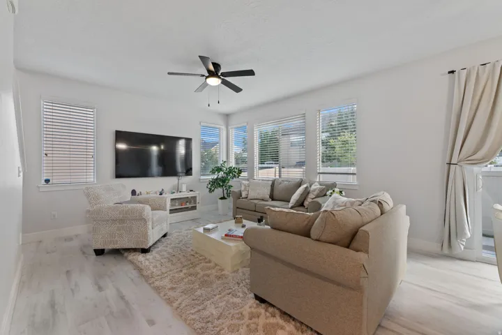 Light wood-finish flooring with a ceiling fan overhead