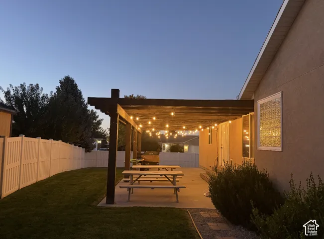 Expansive concrete patio with a wooden pergola structure