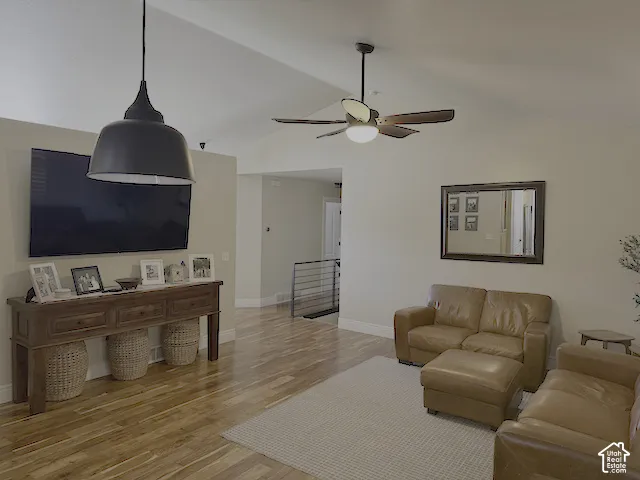 Vaulted ceiling, wood-finish flooring, recessed lighting, ceiling fan with light, modern pendant light fixture