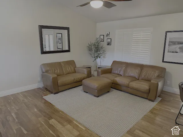 Vaulted ceiling with a ceiling fan, wood-finish flooring, and white louvered window shutters
