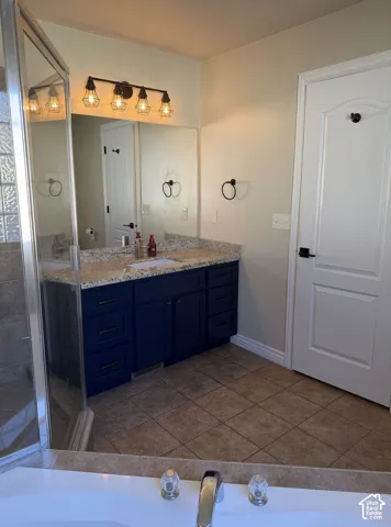 Double vanity with a granite-style countertop and ample storage