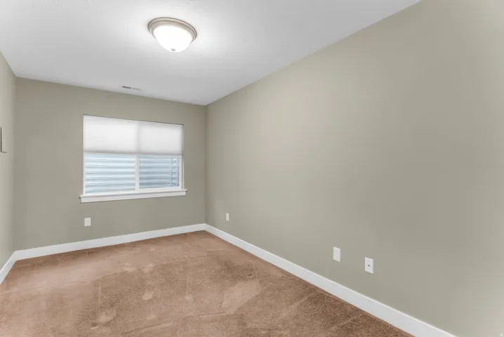 Recessed window with white blinds, neutral wall paint, white trim, and a flush mount ceiling light