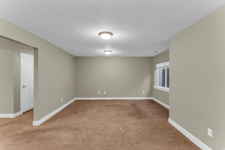 Recessed window with white trim, neutral wall tones, and overhead flush-mount lighting