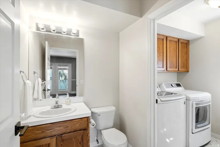 Vanity with a white countertop and wood-finish cabinetry