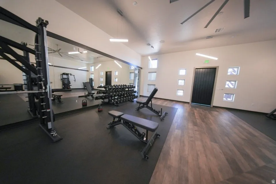 State-of-the-art fitness facility featuring professional-grade strength training equipment, adjustable weight benches, and dumbbell racks