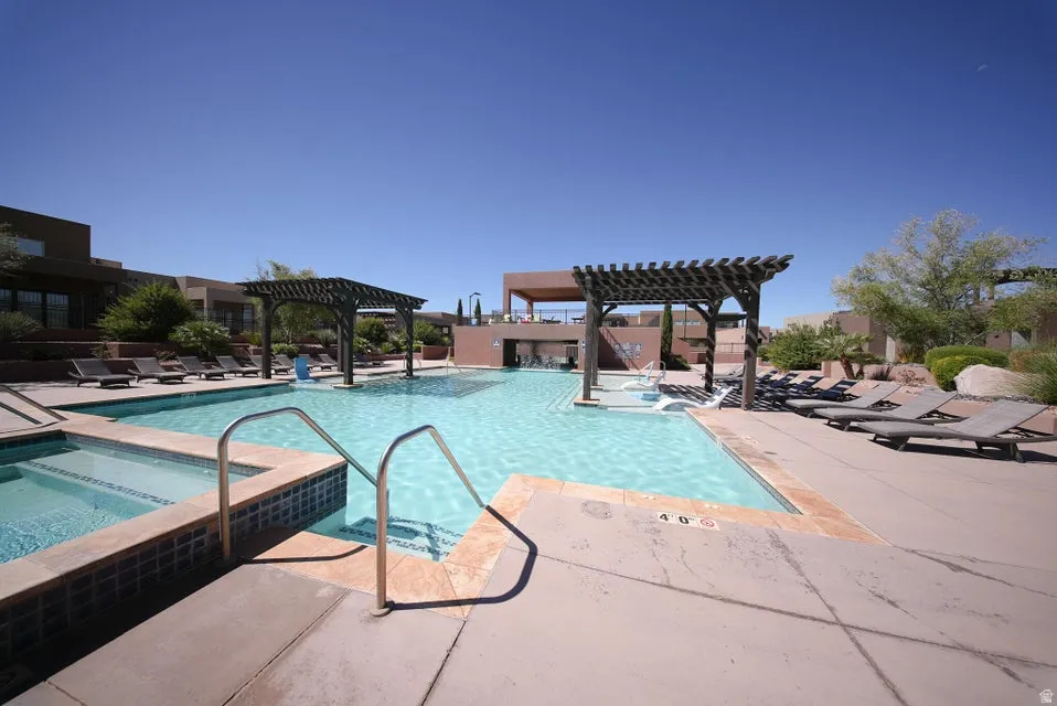 Expansive swimming pool with integrated spa and multiple pergolas