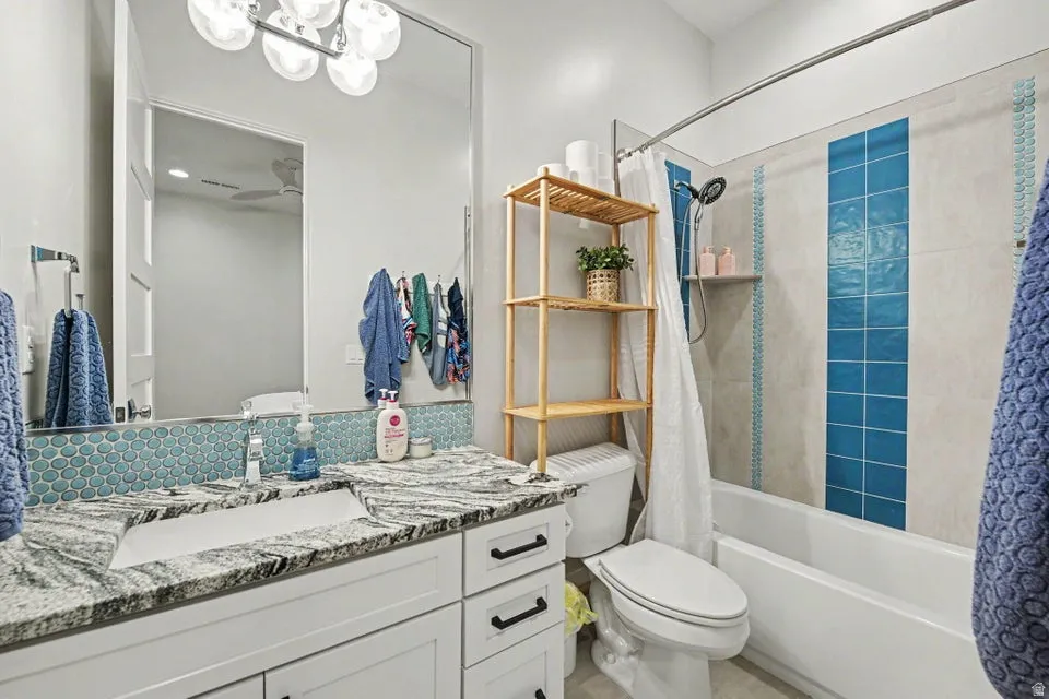 Spa-inspired bathroom featuring a floating vanity with polished stone countertop, dual sink setup, and chrome fixtures