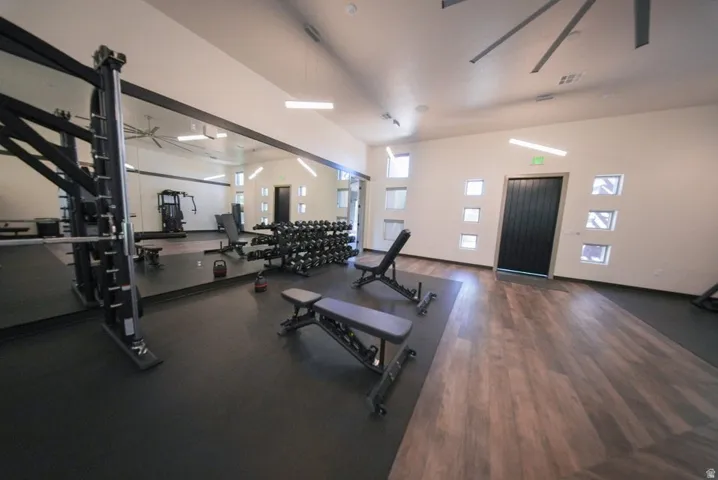 State-of-the-art fitness facility featuring professional-grade strength training equipment, adjustable weight benches, and dumbbell racks