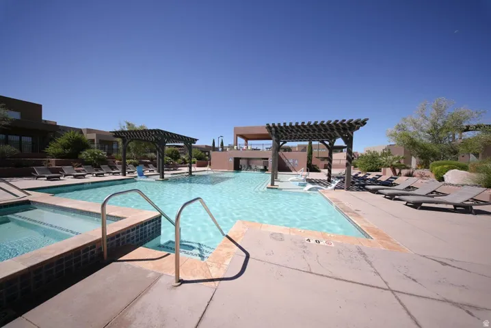 Expansive swimming pool with integrated spa and multiple pergolas