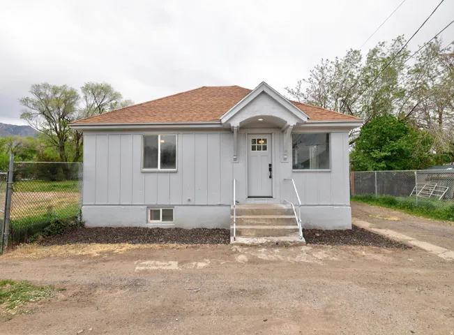 Light gray exterior with vertical siding and white trim