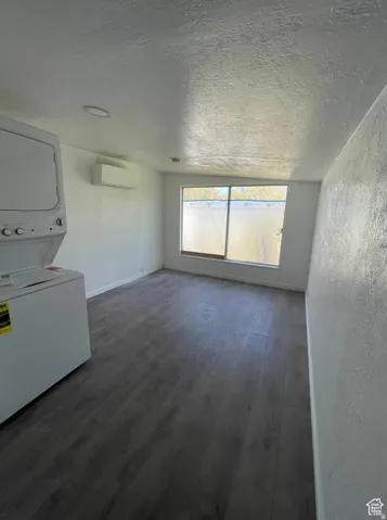 ADU _ Studio Wood-finish flooring, white walls, mini-split air conditioning unit.